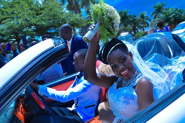 Wilson & Rosette driving from church on their wedding day