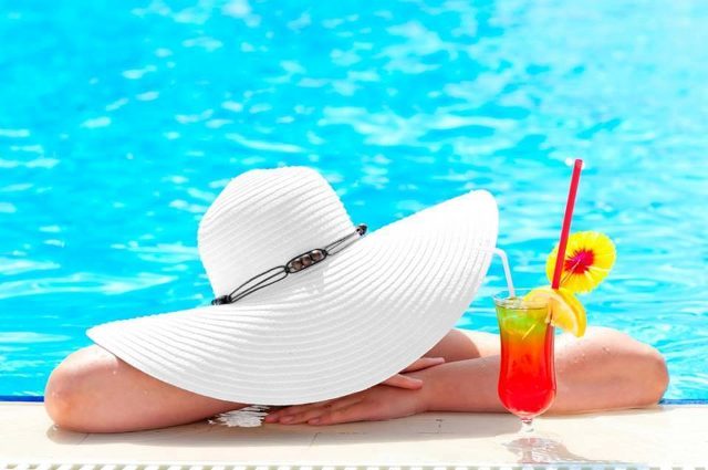 Lady with a cocktail at the Kabira Country Club swimming pool