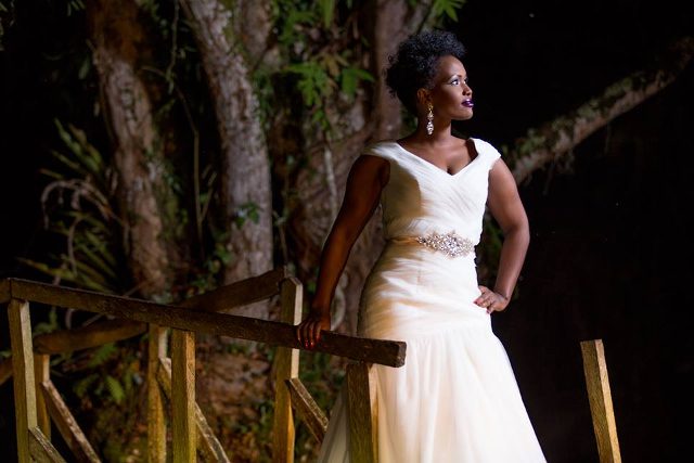 A bride cloaked in an All Tulle white pleated mermaid gown
