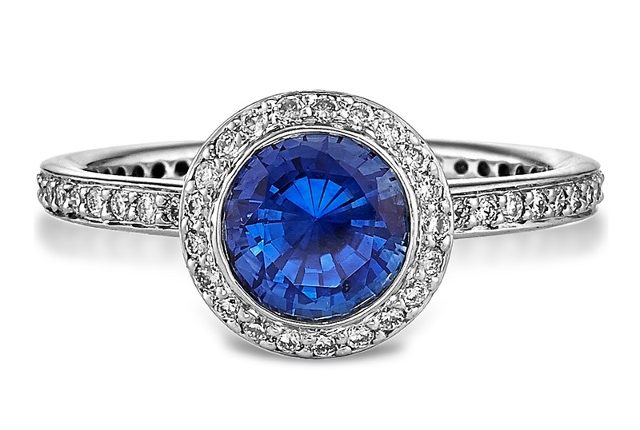 A halo wedding ring with a blue stone from Ahmed Jeweller and Diamond Shop