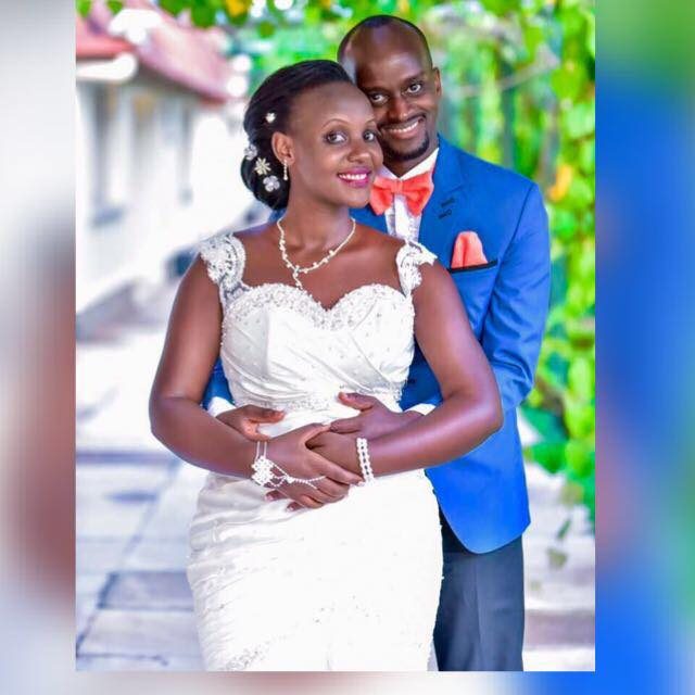 A bride and groom posing for a moment, bride dressed by Nisha's Bridal