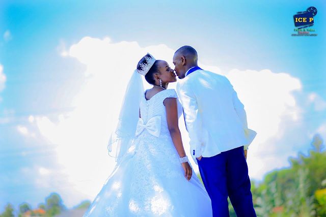 Stanley and Peruth on their wedding day, bride dressed by Visma Resource Center