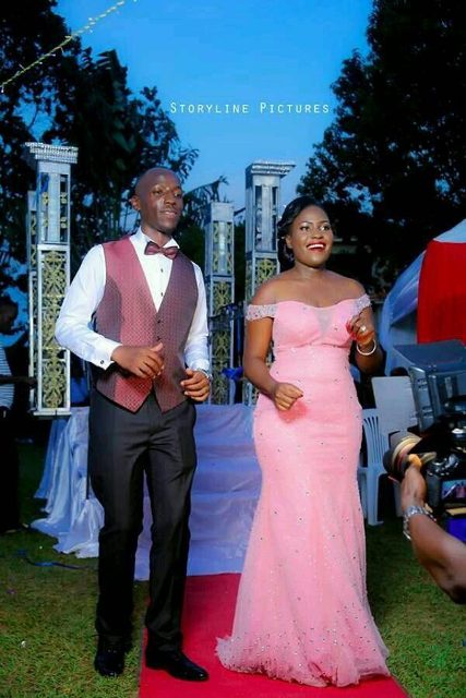 A bride and groom dance at their reception, bride's changing dressed tailored by Peponi Clothings
