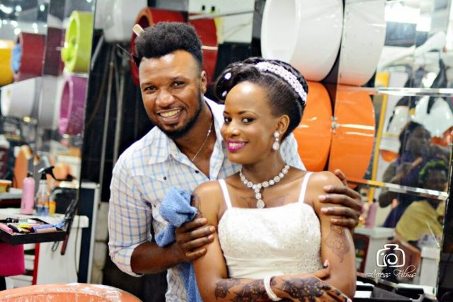 A bride poses for a photo with a Salon lords and ladys attendant, photo by Access Films