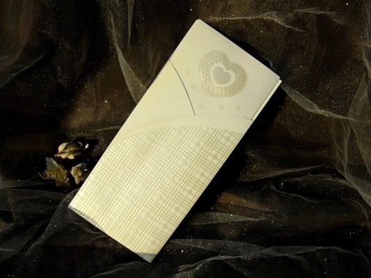 A cream wedding invitation card made by Chic Designs