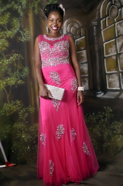 A model in a red changing dress embroidered rhinestones from Aggie's Bridal