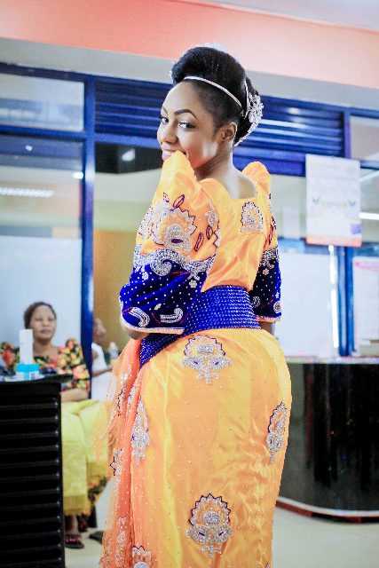 Asha dazzles in a sequined yellow and blue gomesi, photo by Agapix Photography